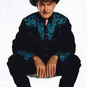 The Last Drive-In with Joe Bob Briggs 2020, a man in a cowboy hat, sitting on a chair.