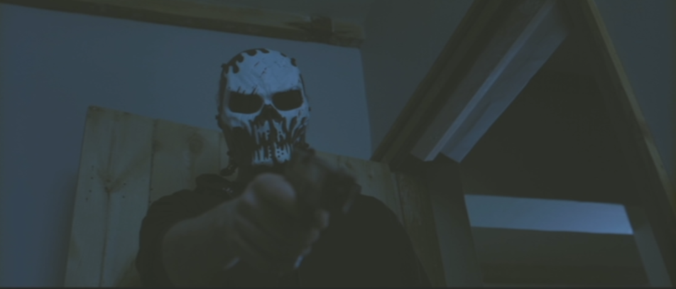 The criminal henchfolks don skull masks and invade homes while armed. (Screen capture from DVD by reviewer Ben Nagy)
