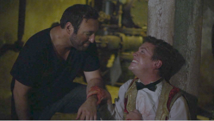 Director Sam (Dave Mussen), left, listens to the pleas of Horatio (Aaron David Johnson) after Horatio was attacked by a zombie in "American Zombieland." (Screen capture from DVD by reviewer Ben Nagy)