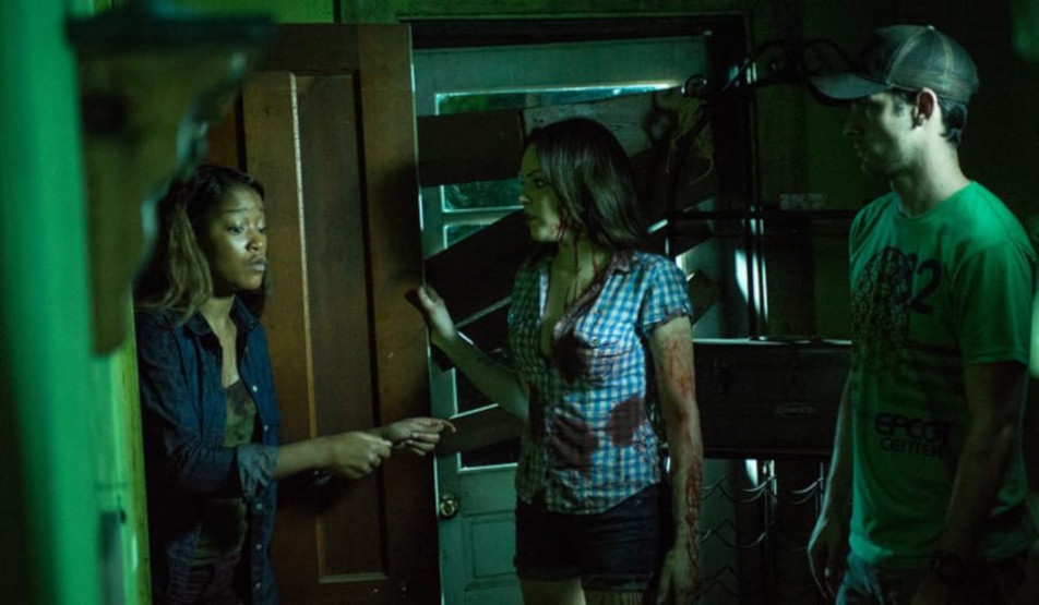 Ben Nagy reviews ‘Animal’: Genetically mutated wildebeest/wolf/bear/boar hybrid makes people hole up in a cabin in the woods 2 Three people standing in front of a door in a dark room.