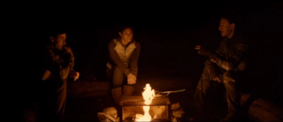 Alex (Jeff Roop), Jenn (Missy Peregrym) and weirdo tour guy with an accent Brad (Eric Balfour) sit around the campfire philosophizing in "Backcountry." (Screen capture by reviewer Ben Nagy)